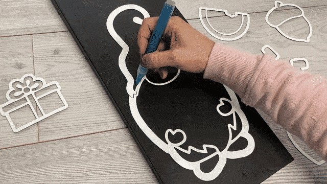 How to paint a stencil without causing stencil bleed by tracing the stencil template along the edge then painting the center demonstrated on the hat of a gnome stencil