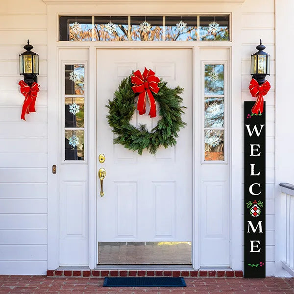 A Christmas welcome sign next to front door, a DIY Christmas decoration crafted with an outdoor chalkboard and letter stencils