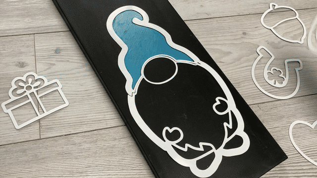How to craft a holiday gnome sign by placing interchangeable design stencil in the gnome template