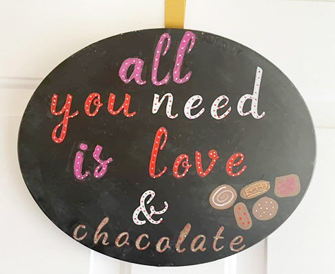 All you need is love and chocolate Valentine’s day chalkboard crafted by a customer using our Plata Oval chalkboard craft kit with chalkboard letter stencils and stencil painting pens