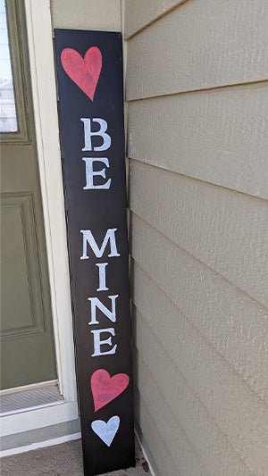 Be Mine Valentine's day chalkboard sign UGC, customer stencils letters in white and stencils large red hearts to create a Valentine's Door Sign