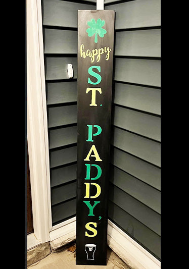 Vertical chalkboard sign for St. Patrick's Day with 'Happy ST. PADDY'S' in alternating green and gold letters, complemented by a shamrock and a pint glass, crafted with stencils for a fun St. Patrick's Day Sign