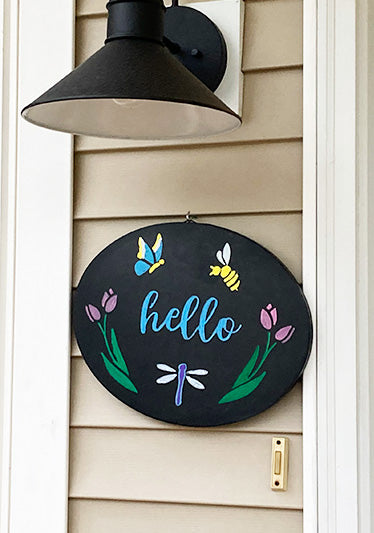 Round frameless chalkboard sign with 'hello' flower and butterfly chalk art, homemade summer welcome sign