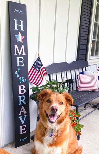 4th of July sign 'Home of the Brave' welcome sign crafted with letter stencils, paint pens on a large blackboard sign