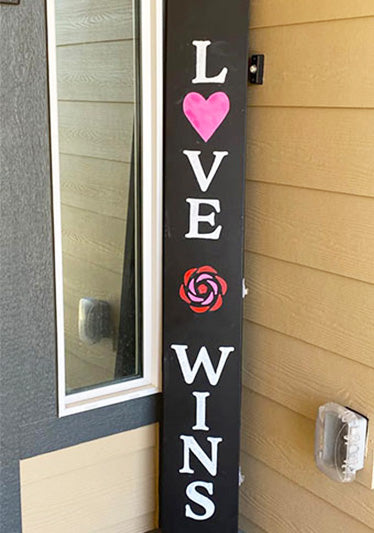 Handmade Valentine's Day sign Love Wins outdoor welcome sign stenciled with lettering stencils on large magnetic chalkboard