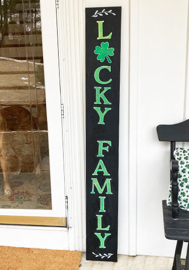 5 foot tall porch sign outdoor chalk board with 'LUCKY FAMILY' stenciled in bold green letters with letter stencils and shamrock stencils, creating a heartwarming St. Patrick's Day chalkboard sign