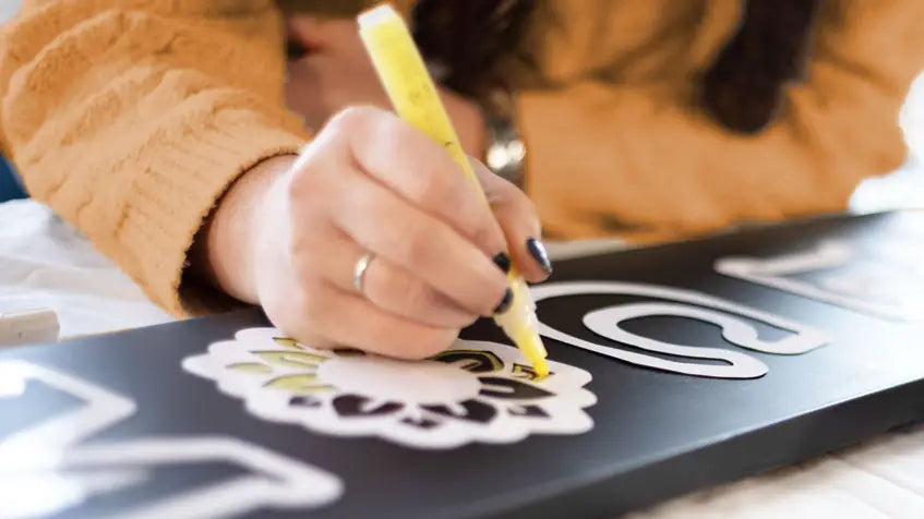 woman making a DIY welcome sign porch chalkboard with Plata Chalkboards craft kit