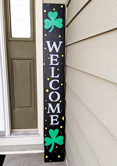Handcrafted vertical porch sign featuring 'WELCOME' in white letters with shamrock embellishments, representing a festive Irish welcome. Perfect as a seasonal porch sign for St. Patrick's Day