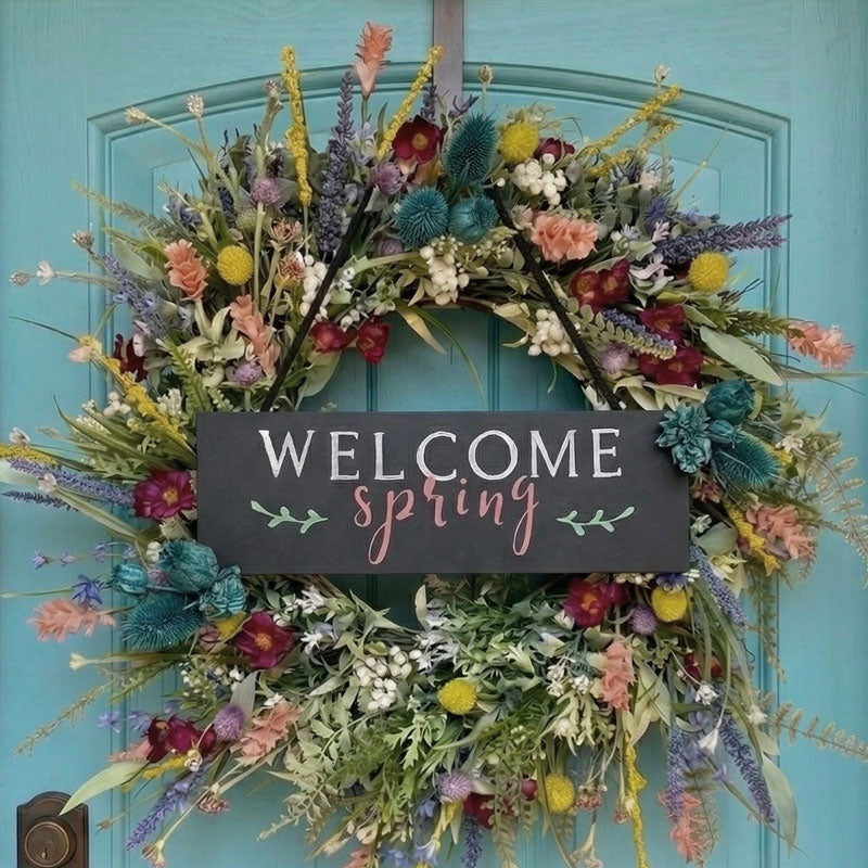 Floral wreath with 'Welcome Spring' sign on a turquoise door