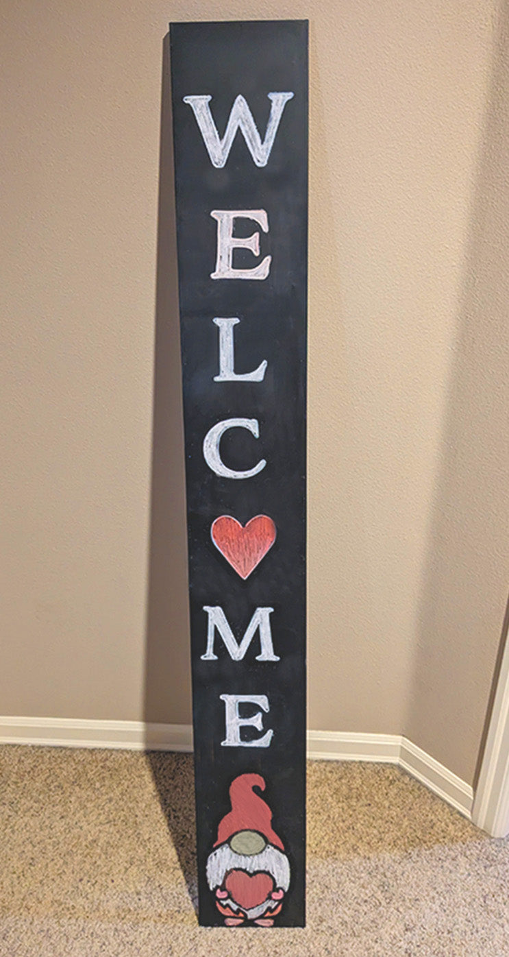 A cute Valentine's Day gnome sign porch chalkboard crafted by one of our customers using a heart stencil for the O in welcome and the gnome stencil is holding a heart