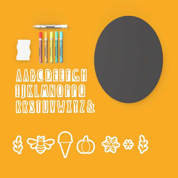 A display of everything included with Plata oval chalkboard sign craft kit- 11" x 14" oval chalkboard, alphabet of magnetic letter stencils, seasonal design stencils (bee, ice cream cone, pumpkin, snowflake stencils), 6 chalk markers and chalkboard eraser for easy DIY signs