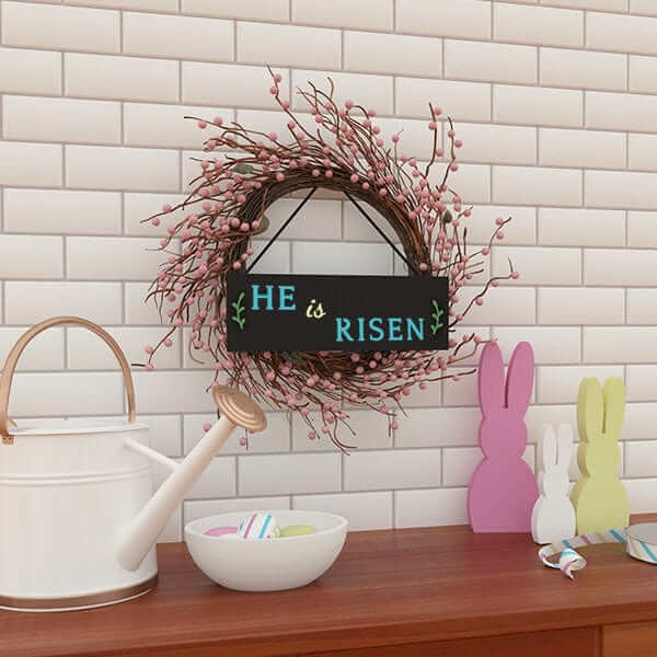 &#39;He is Risen&#39; Easter chalkboard sign hung on a pink wreath crafted with chalkboard lettering stencils