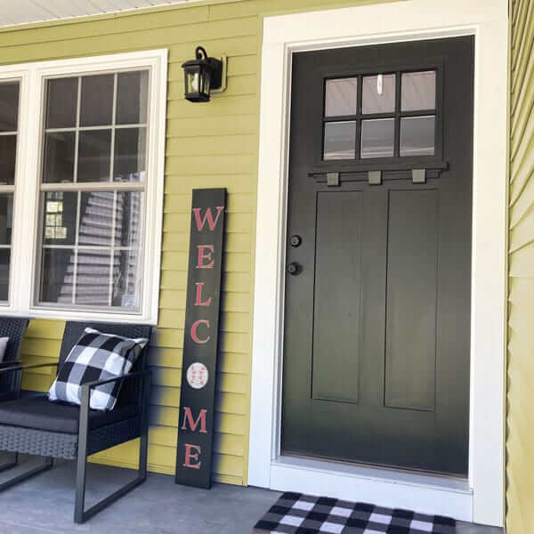 A baseball welcome sign with the &#39;o&#39; for welcome replaced with a baseball, crafted using letter stencils and baseball stencils on an outdoor chalkboard sign