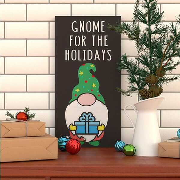 A Gnome for the Holidays Christmas chalkboard sign made with Plata Chalkboards Magnetic chalkboard stencils- crafted with gnome stencil and present stencil displayed on a tabletop.