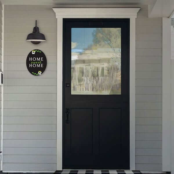 Home Sweet Home Sign Oval Chalkboard next to front door of farmhouse. Chalkboard sign made with letter stencils and paint pens to create a DIY Chalkboard Sign
