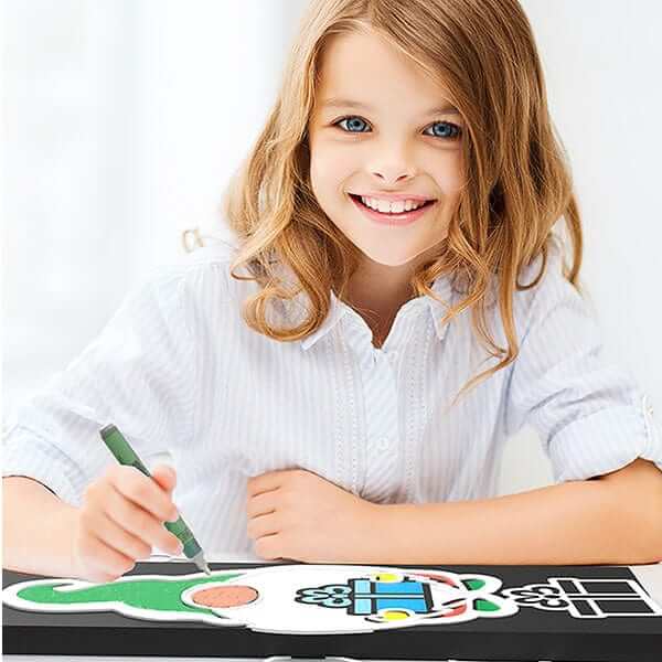 Young girl coloring stencils on a chalkboard to craft a gnome Christmas chalkboard sign with Plata Chalkboards Magnetic chalkboard stencil craft kit