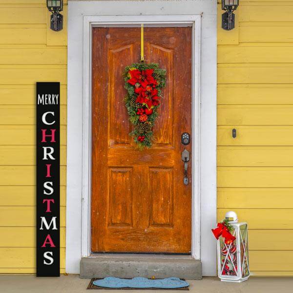 5 foot Vertical Tall Christmas Sign Porch Chalkboard by Plata Chalkboards that is stenciled Merry Christmas next to farmhouse front door decorated for Christmas 